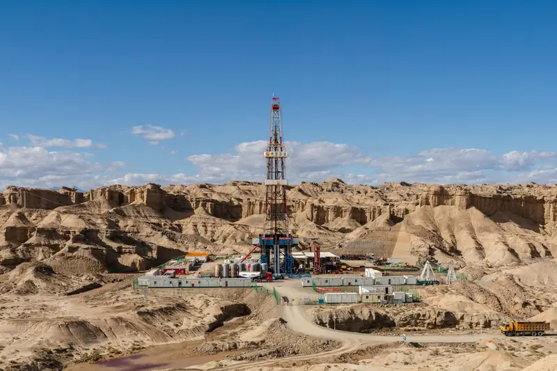 Drilling rig in a desert canyon landscape